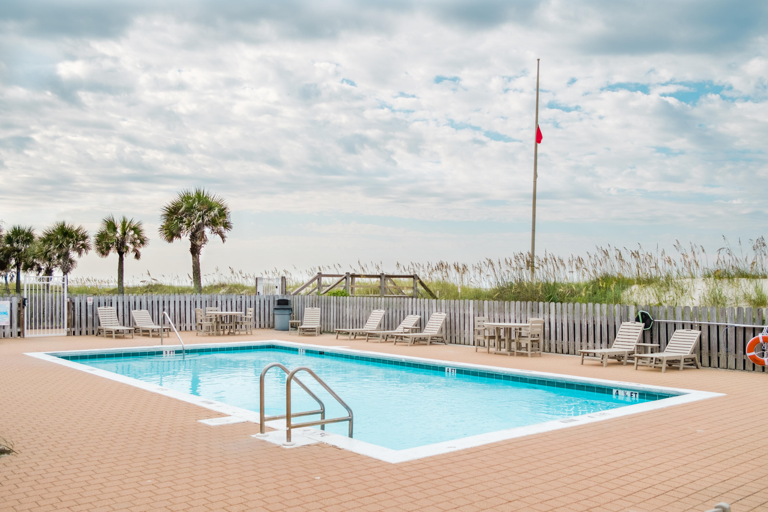 23011 Front Beach Road, Unit 58 Panama City Beach, FL 32413 - Photo 28 of 32 a view of a swimming pool with a terrace