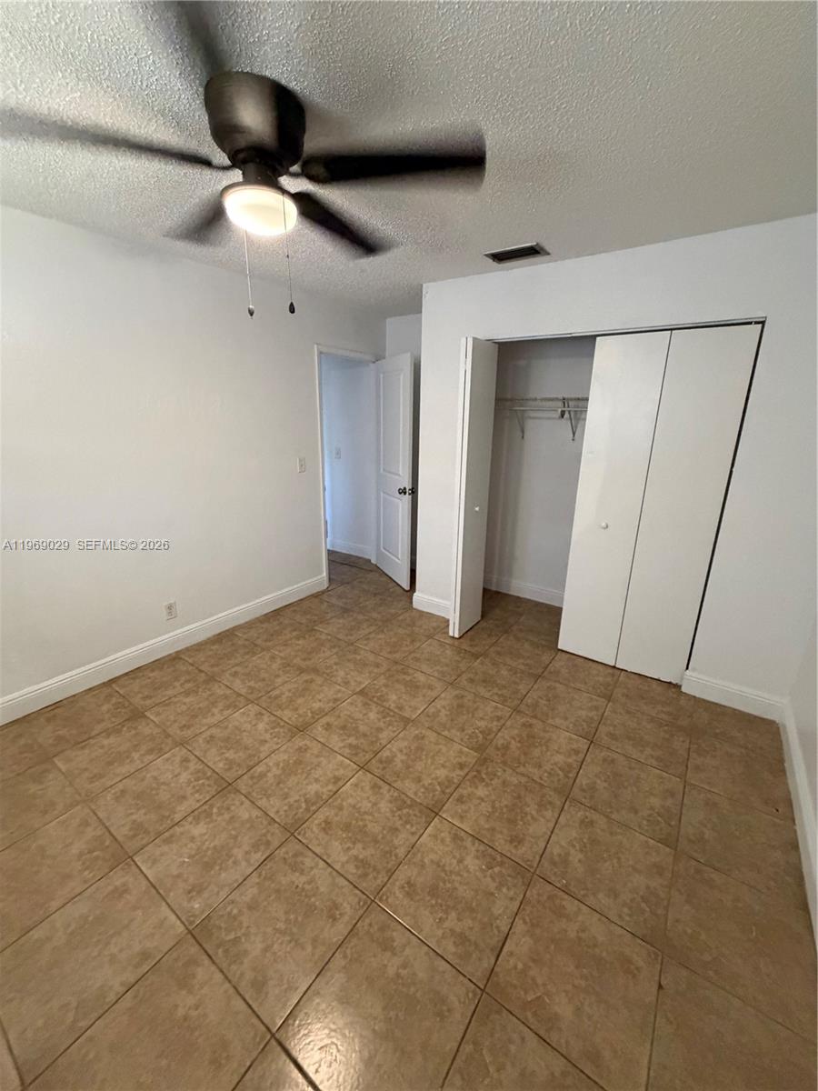 356 Southwest 2nd Place Pompano Beach, FL 33060 - Photo 9 of 23 a view of an empty room and a ceiling fan