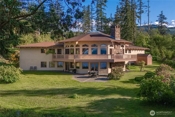 a front view of a house with a garden and swimming pool