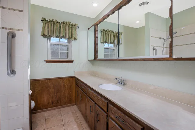 a bathroom with a bath tub with a shower