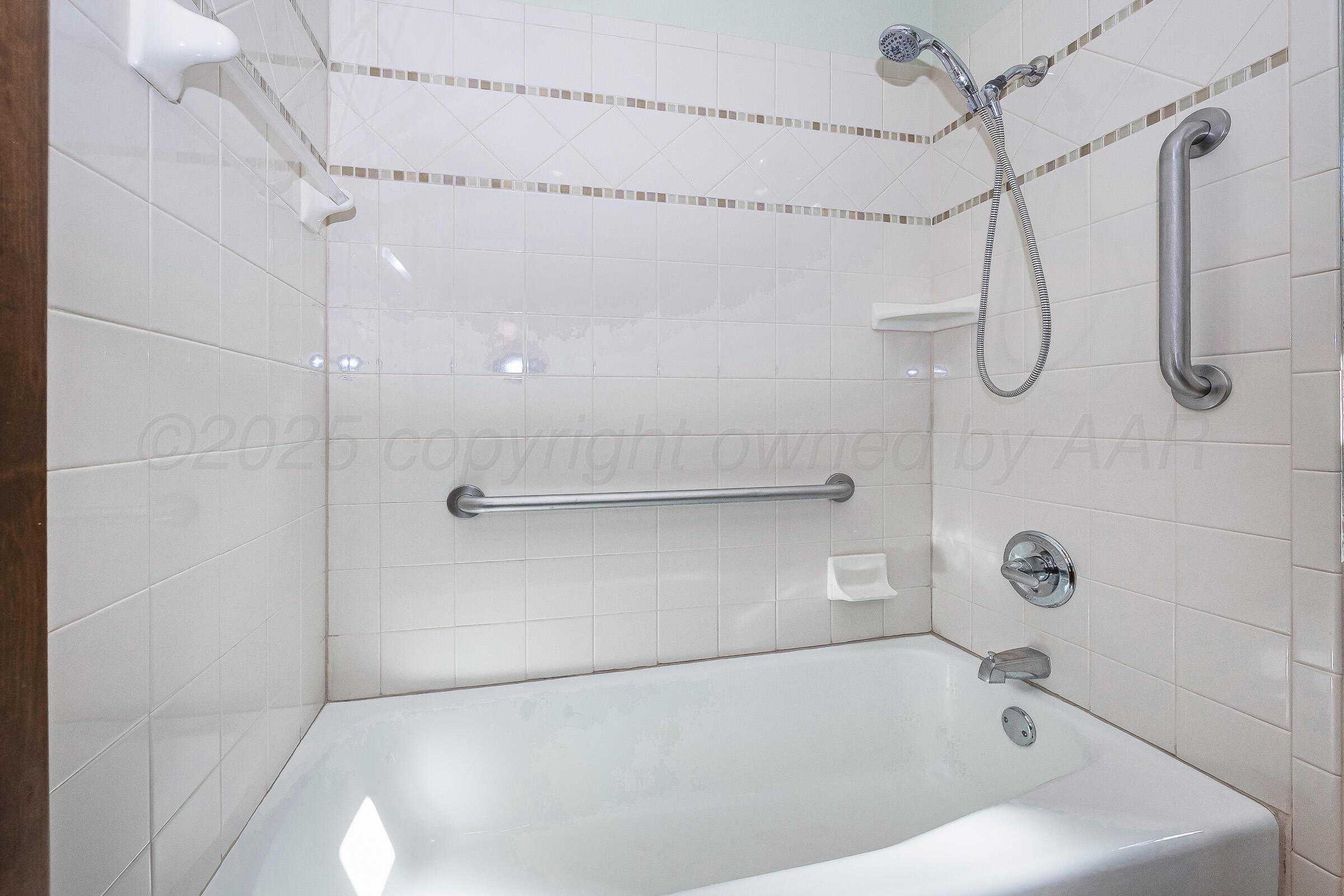 5312 Briar Street Amarillo, TX 79109 - Photo 20 of 27 a bathroom with a bath tub with a shower