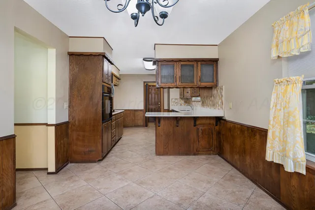 a kitchen with stainless steel appliances granite countertop a refrigerator and a stove