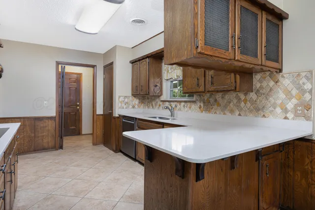 a kitchen with stainless steel appliances granite countertop a sink and cabinets