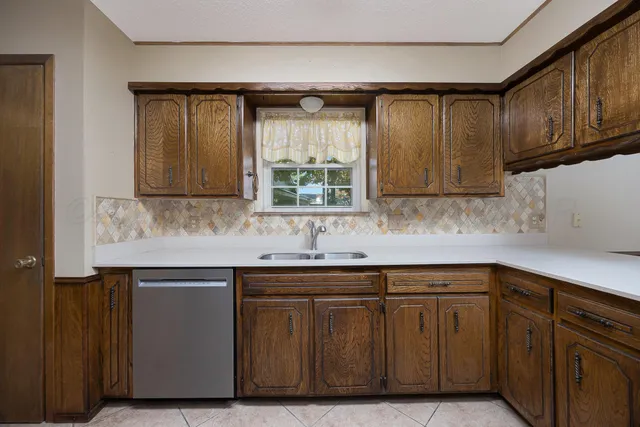 a kitchen with stainless steel appliances granite countertop a sink and a microwave
