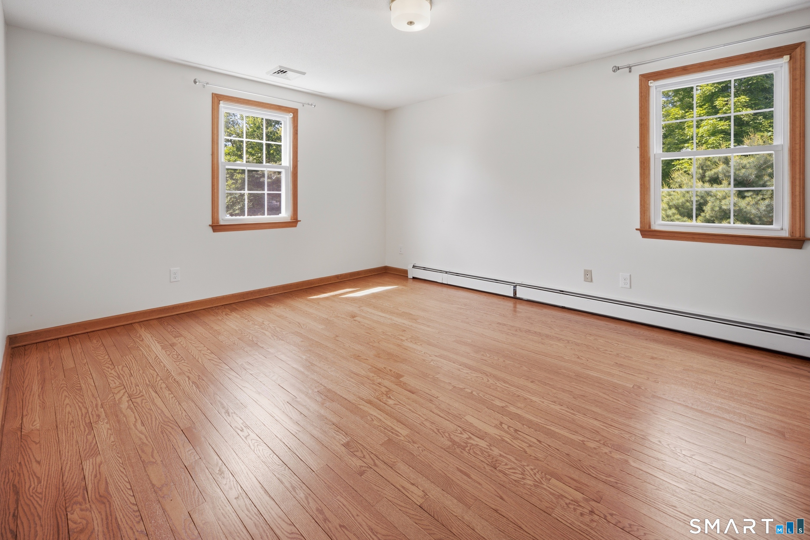 211 Valley View Road Manchester, CT 06040 - Photo 29 of 39 an empty room with wooden floor and windows