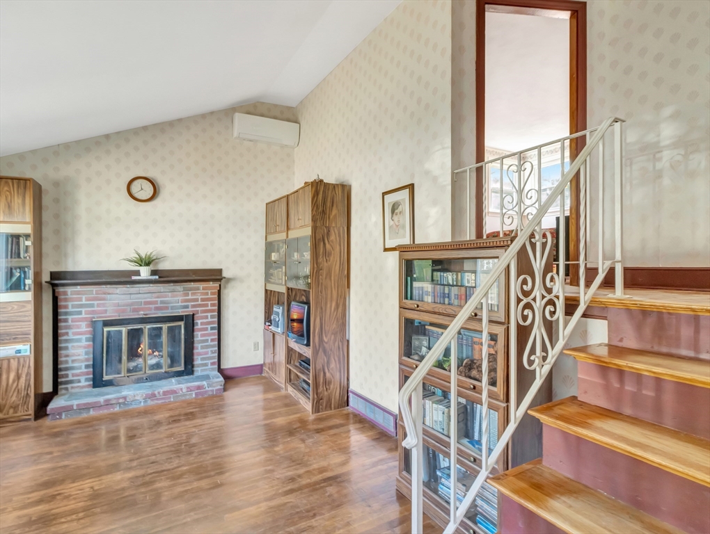 9 Madison Avenue Randolph, MA 02368 - Photo 11 of 30 a view of an empty room with wooden floor fireplace and a window