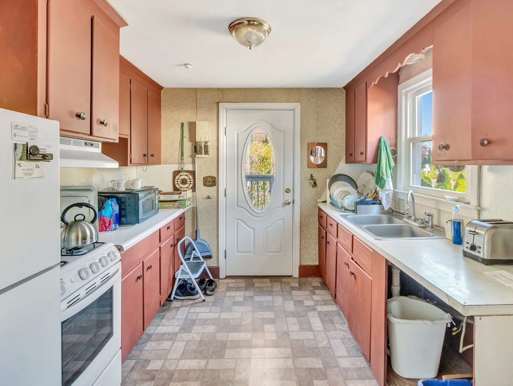 9 Madison Avenue Randolph, MA 02368 - Photo 15 of 30 a very nice looking open kitchen with stainless steel appliances granite countertop a stove a sink a refrigerator and a dining table