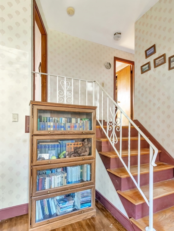 9 Madison Avenue Randolph, MA 02368 - Photo 17 of 30 a view of staircase with lots of frames on wall and a window