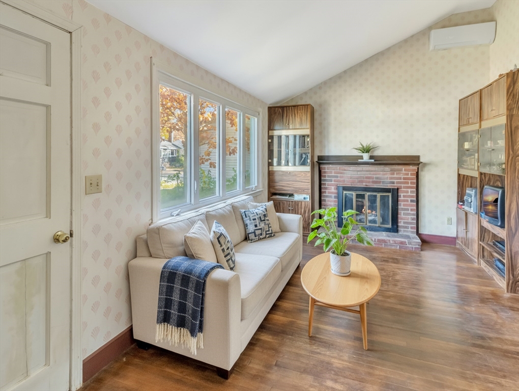 9 Madison Avenue Randolph, MA 02368 - Photo 9 of 30 a living room with furniture a large window and a fireplace