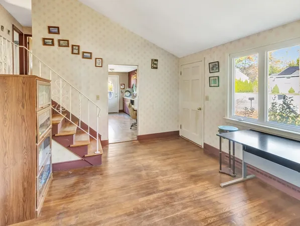 a view of entryway and hall with wooden floor