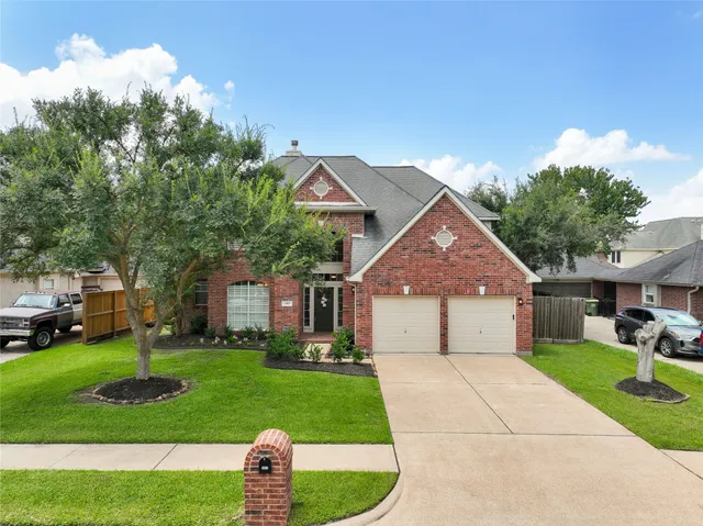 a front view of house with yard and green space