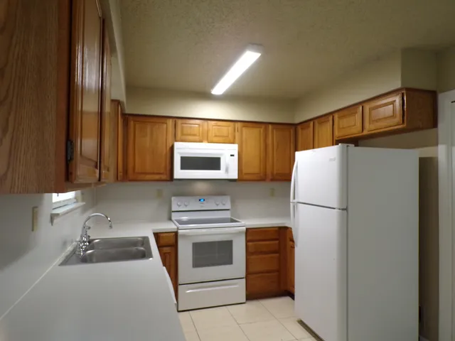 a kitchen with a refrigerator sink and stove