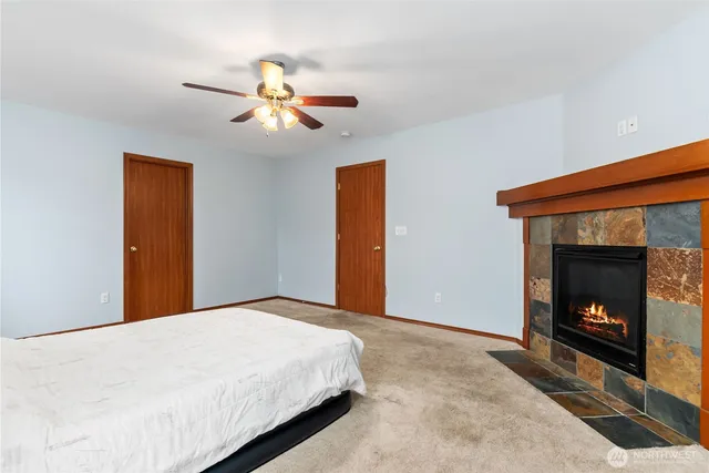 a bedroom with a bed and a fireplace