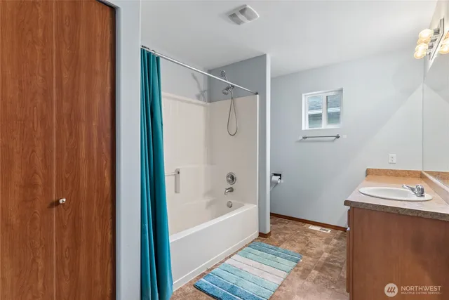 a bathroom with a tub and shower