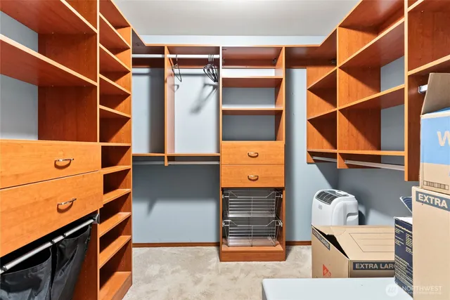 a view of walk in closet with empty racks