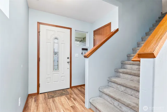 a view of entryway with wooden floor and stairs