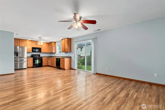 a view of a kitchen with a stove cabinets and wooden floor