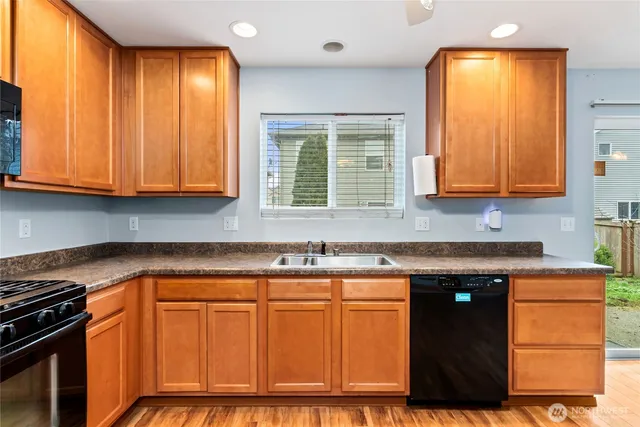 a kitchen with granite countertop cabinets sink and window