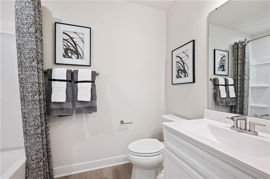 223 Elk Rdg Drive Moon Township, PA 15108 - Photo 13 of 17 a bathroom with a toilet a sink and a large mirror