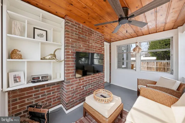 a outdoor living space with furniture and a flat screen tv