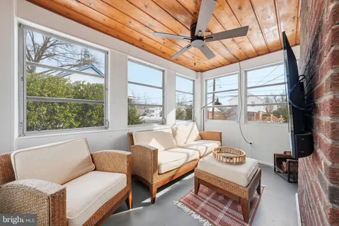 a bedroom with furniture and a large window