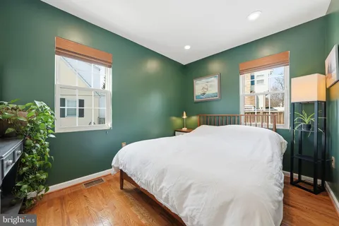 a bed sitting in a bedroom next to a window