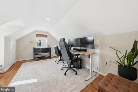 a view of a workspace with furniture and a potted plant