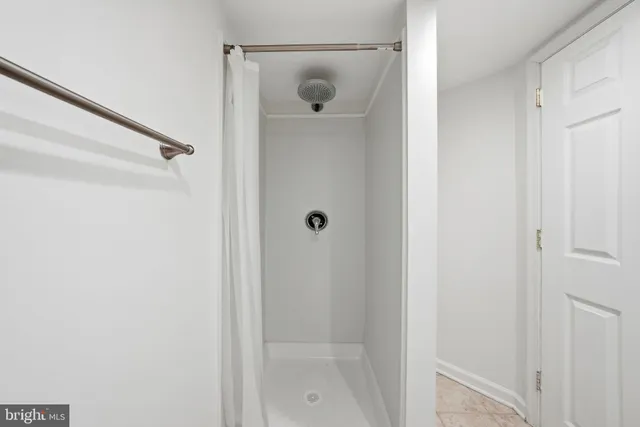 a bathroom with a glass shower door