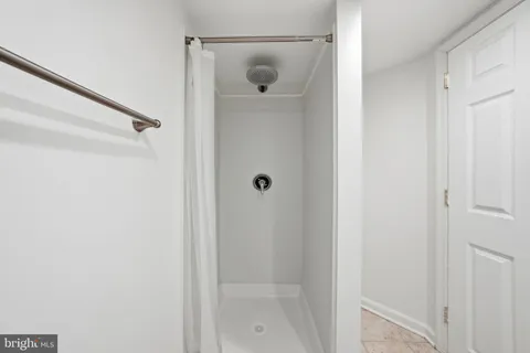 a bathroom with a glass shower door