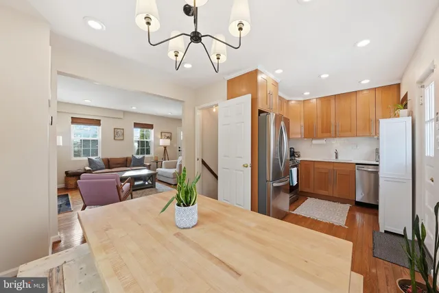 a kitchen with stainless steel appliances kitchen island granite countertop a refrigerator and a sink