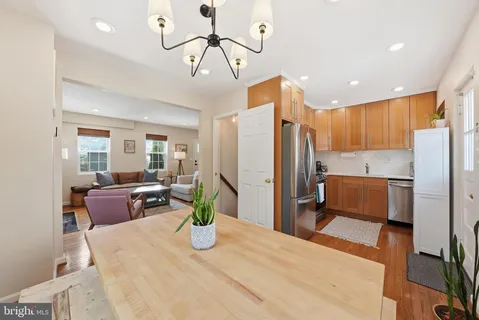a kitchen with stainless steel appliances kitchen island granite countertop a refrigerator and a sink