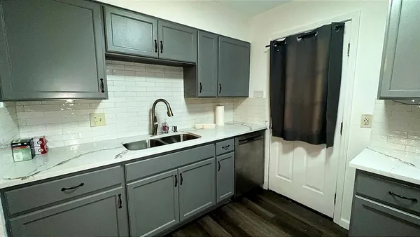 an empty room with a chandelier fan