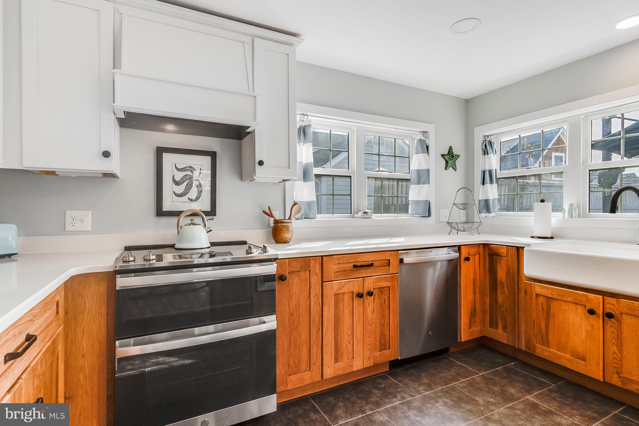 112 West 3rd Street Lewes, DE 19958 - Photo 27 of 73 a kitchen with stainless steel appliances granite countertop a sink stove and cabinets