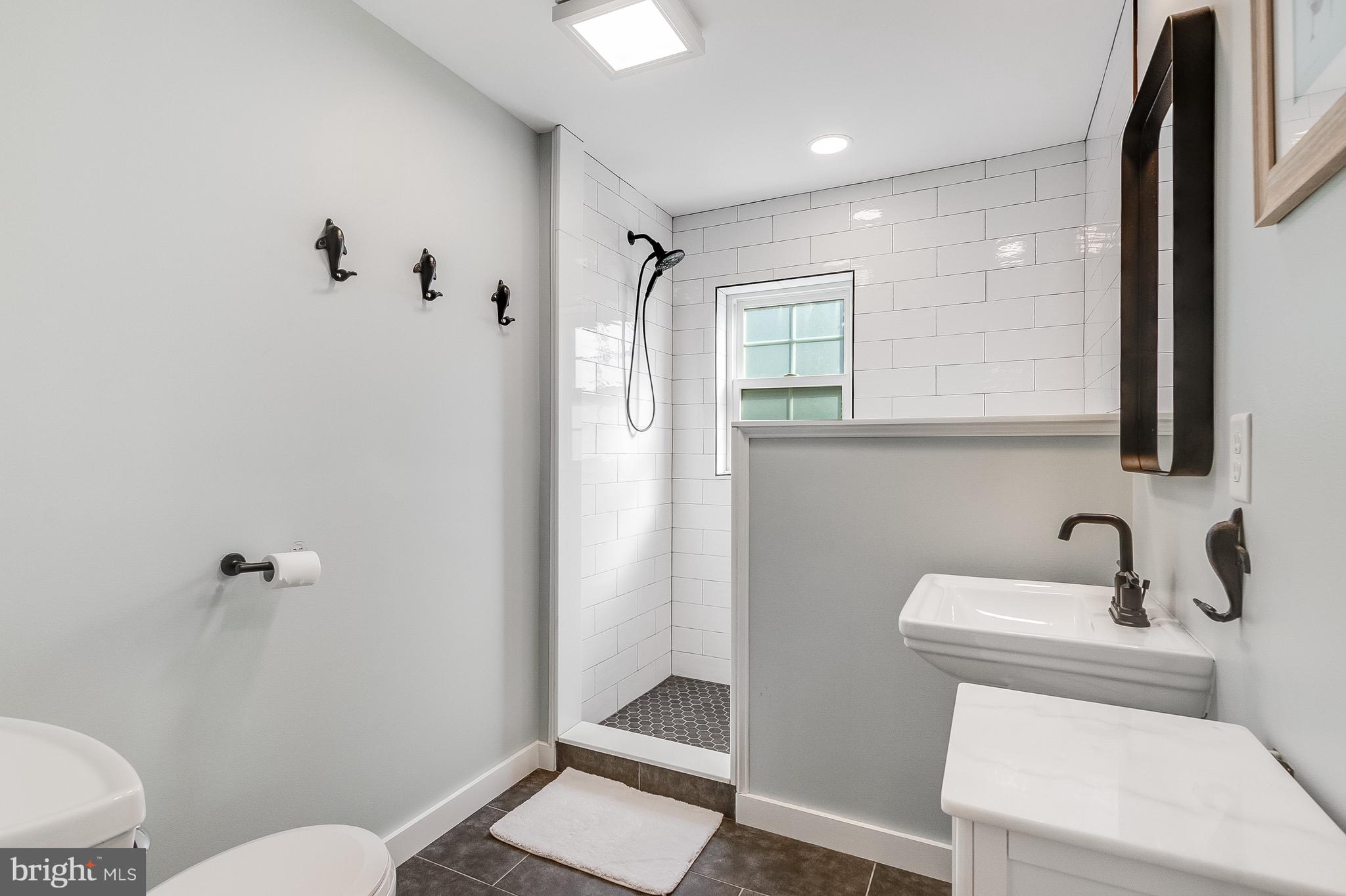 112 West 3rd Street Lewes, DE 19958 - Photo 30 of 73 a bathroom with a sink toilet and shower