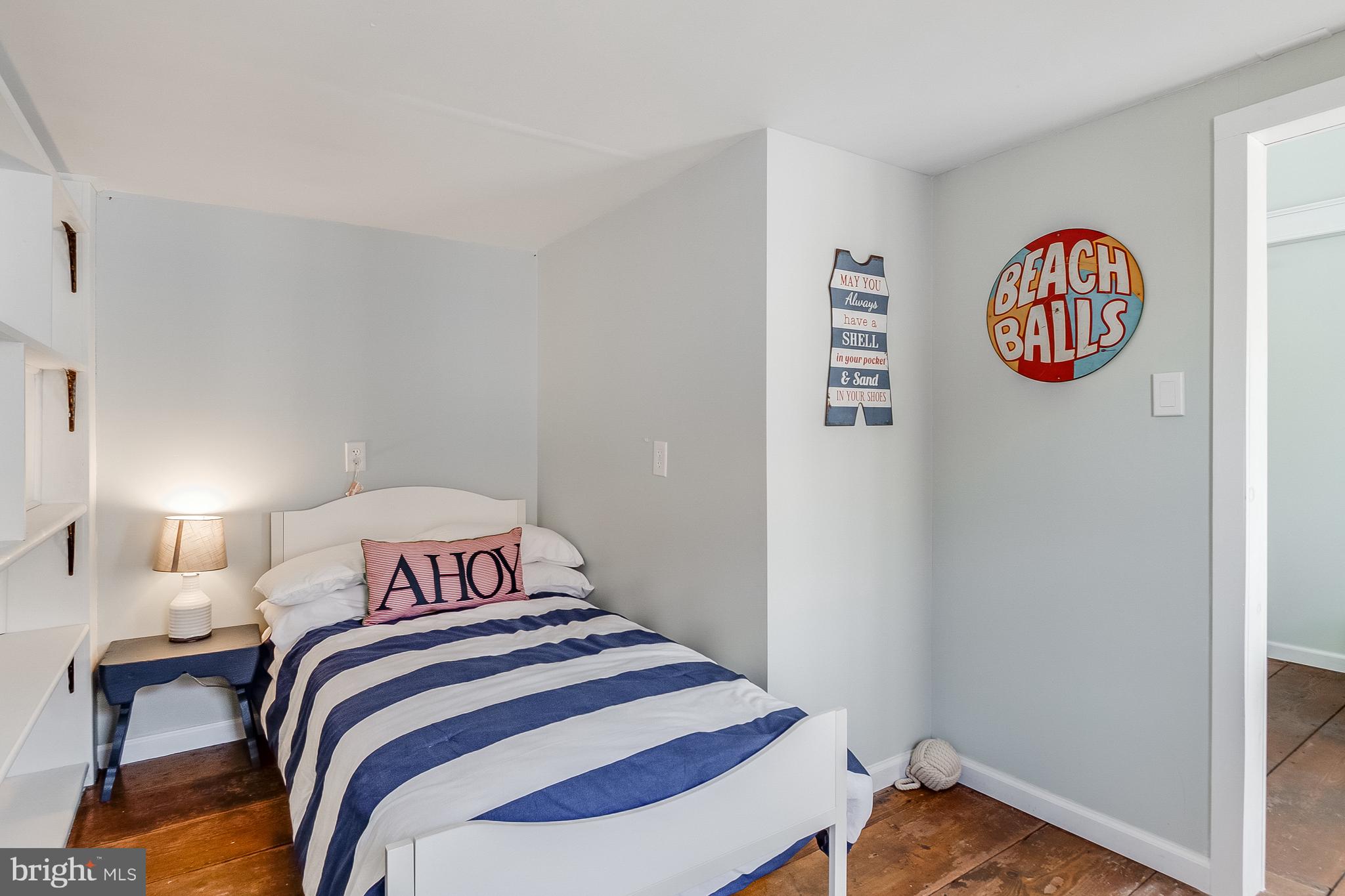 112 West 3rd Street Lewes, DE 19958 - Photo 52 of 73 a bedroom with a bed and a lamp on dresser