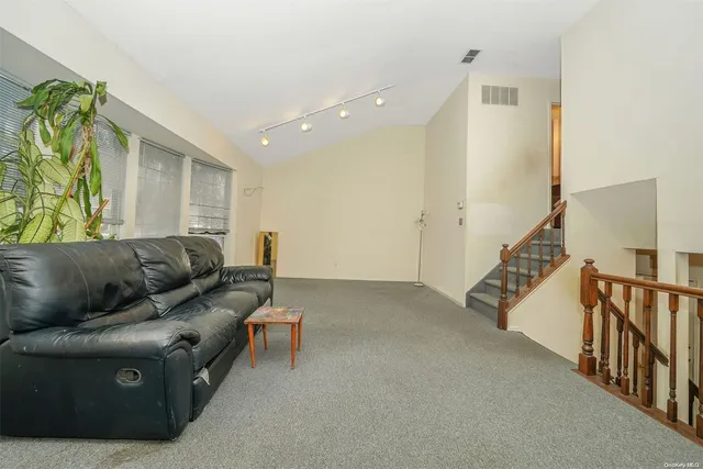 a living room with furniture and stairs