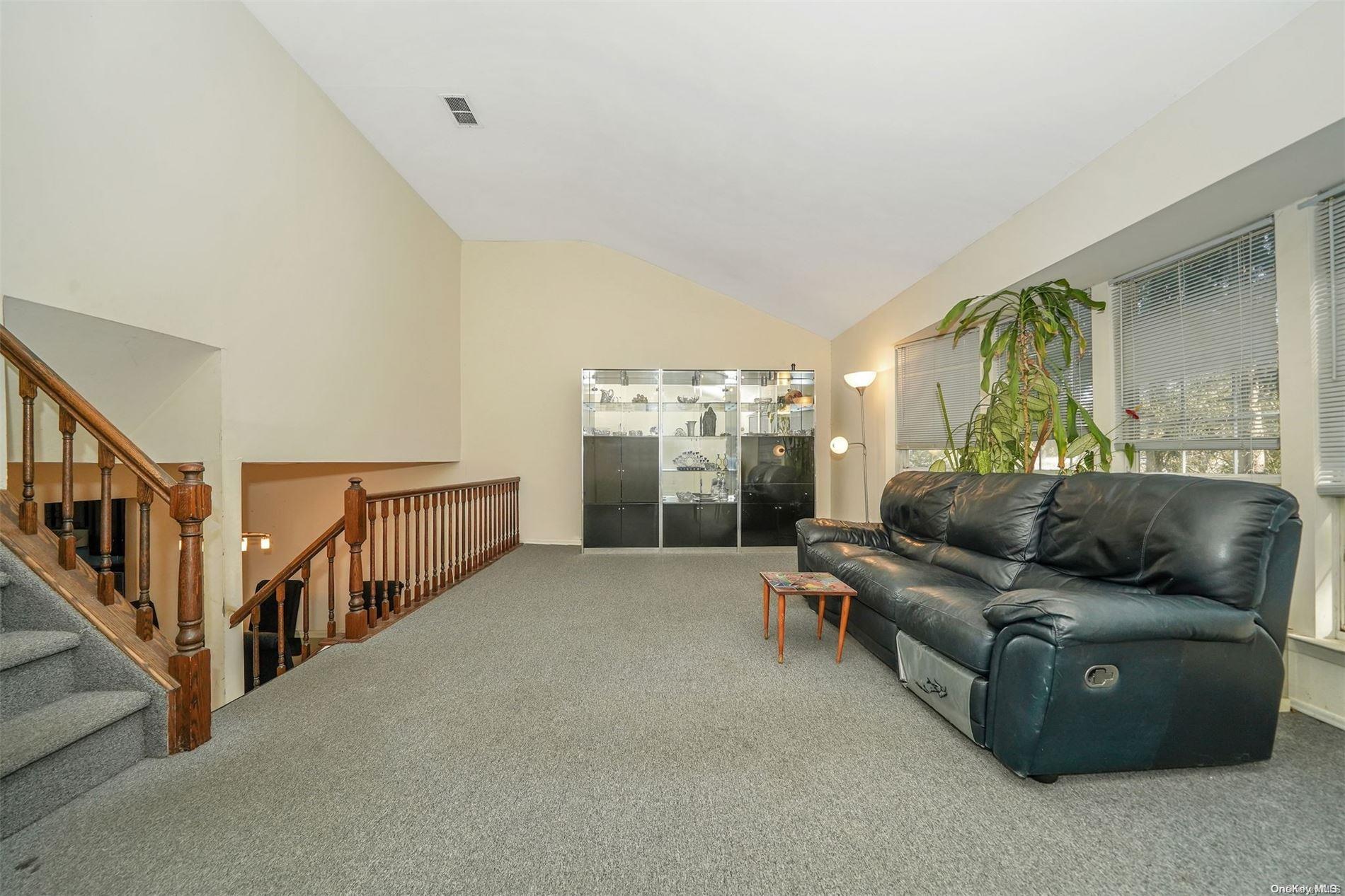 37 Santa Barbara Drive, Unit 37 Plainview, NY 11803 - Photo 12 of 32 a living room with furniture and stairs
