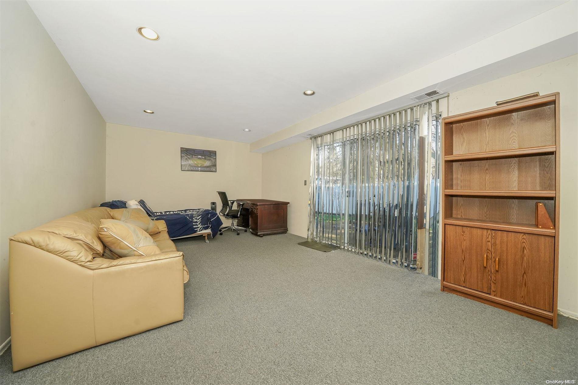 37 Santa Barbara Drive, Unit 37 Plainview, NY 11803 - Photo 20 of 32 a living room with furniture and a window