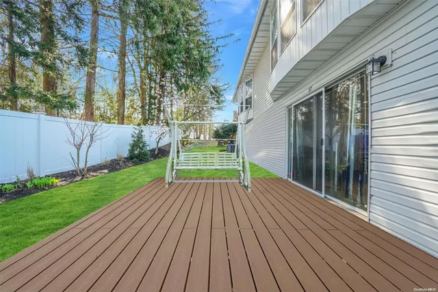 a view of a house with a yard and deck