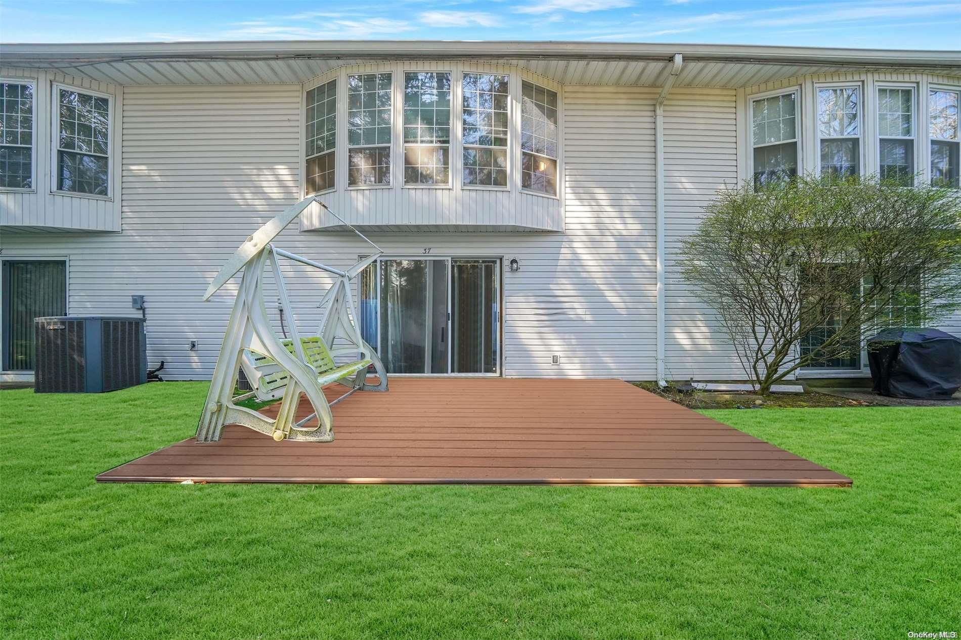 37 Santa Barbara Drive, Unit 37 Plainview, NY 11803 - Photo 24 of 32 a view of a house with a yard and deck