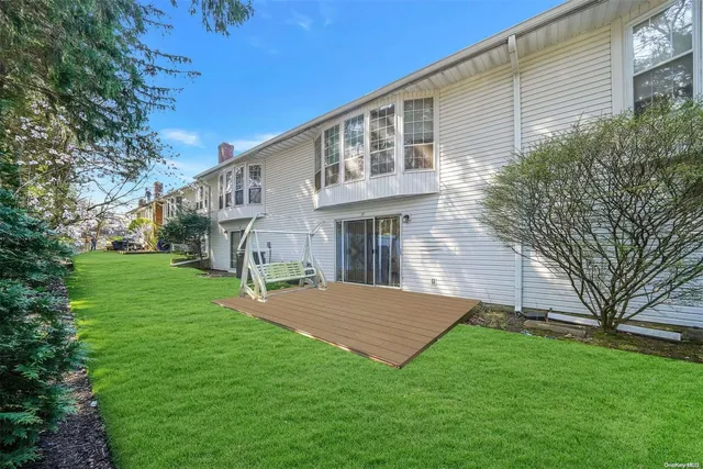 a front view of a house with a garden and yard