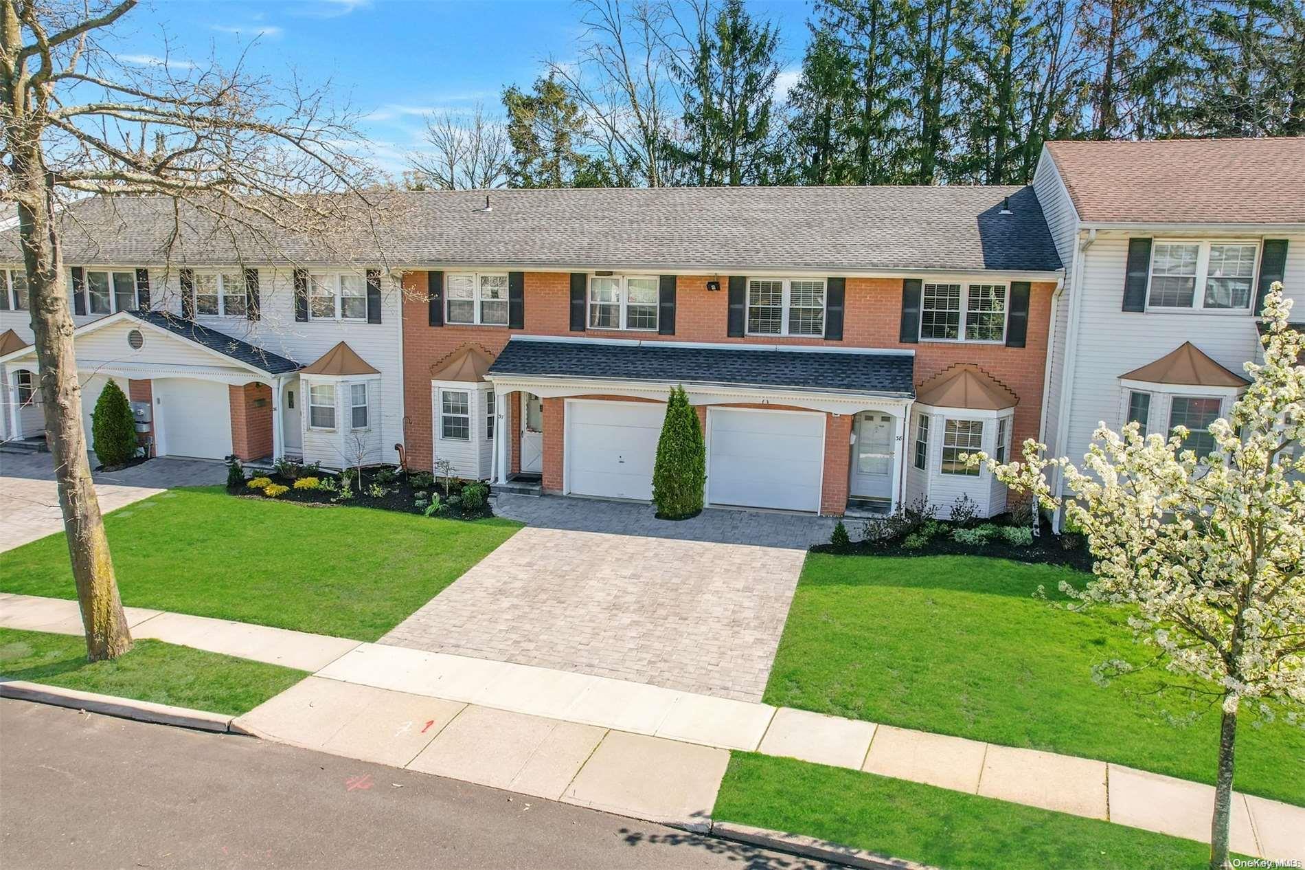 37 Santa Barbara Drive, Unit 37 Plainview, NY 11803 - Photo 26 of 32 a front view of a house with a garden and yard