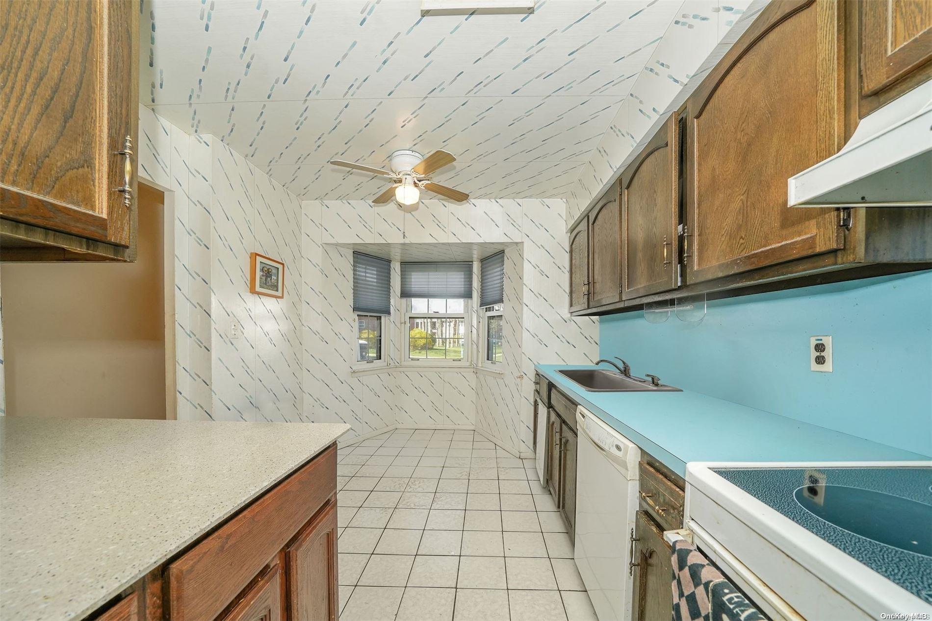 37 Santa Barbara Drive, Unit 37 Plainview, NY 11803 - Photo 7 of 32 a view of a kitchen with a sink and dishwasher