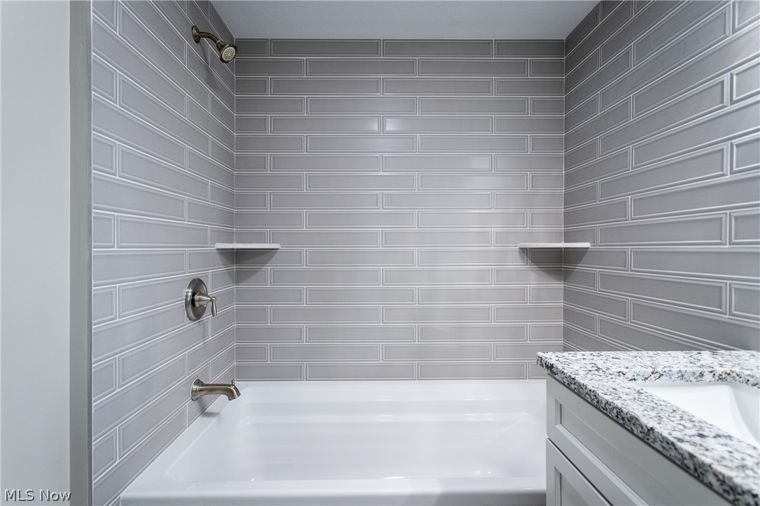 2728 Lander Road Cleveland, OH 44124 - Photo 36 of 50 Bathroom featuring vanity and tiled shower / bath combo