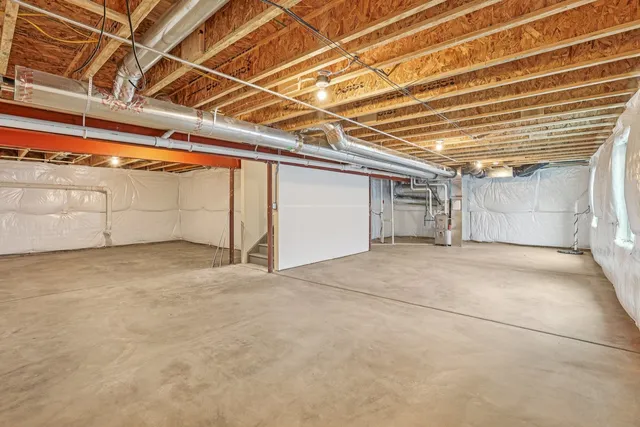 a kitchen with a table chairs refrigerator and cabinets