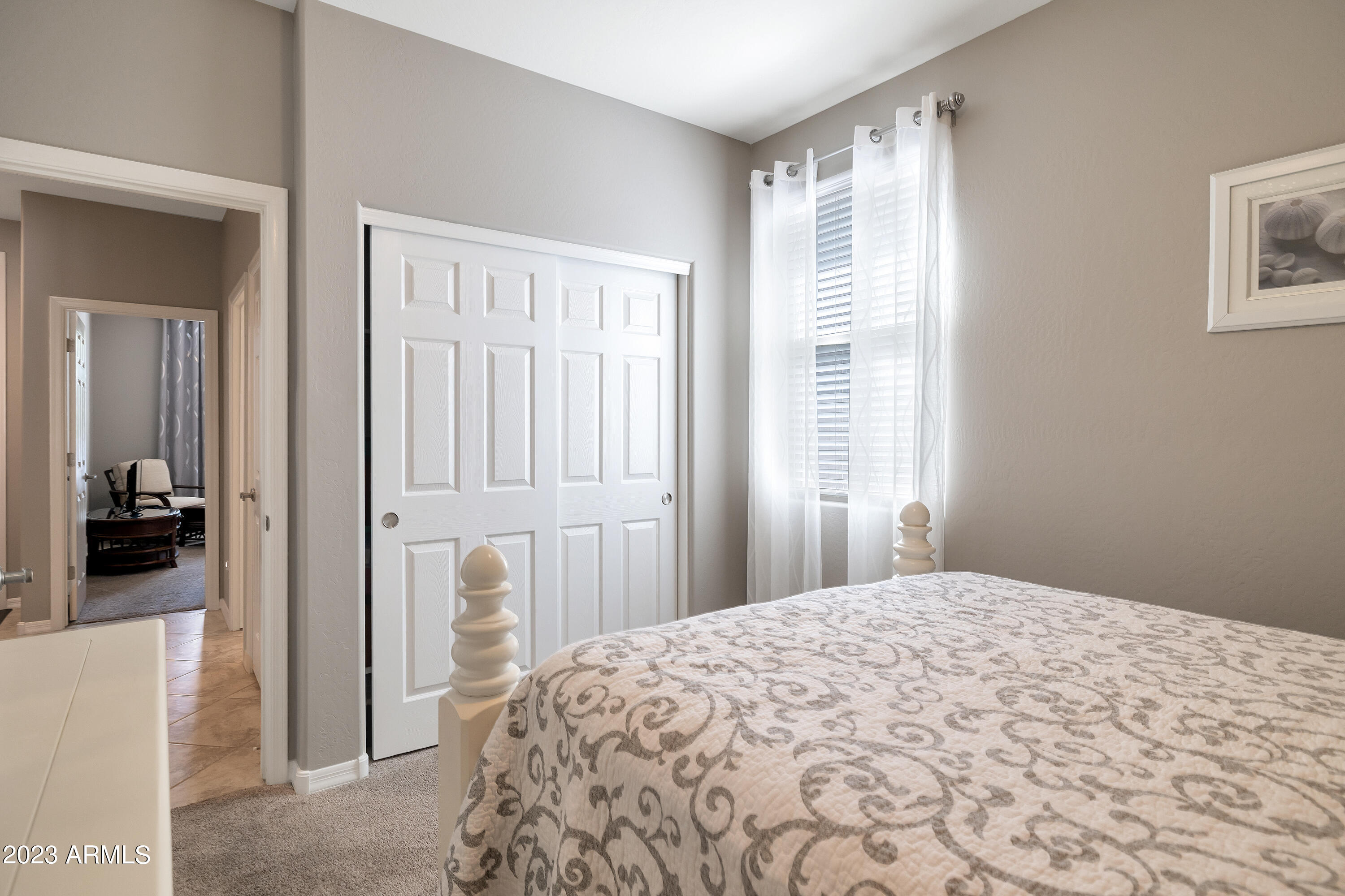 21218 West Granada Road Buckeye, AZ 85396 - Photo 26 of 34 a bedroom with a bed and a large mirror