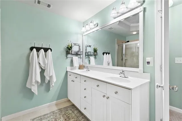 a bathroom with a double vanity sink and mirror