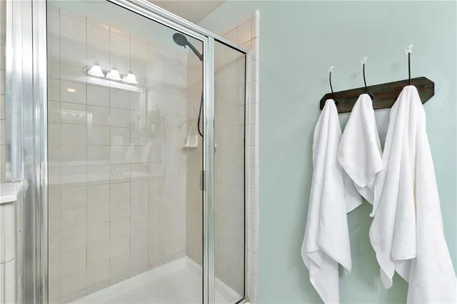 a bathroom that has a glass shower door