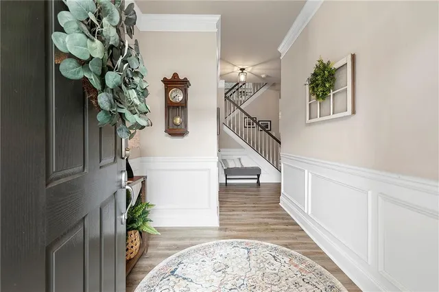 a view of entryway with paintings on the wall