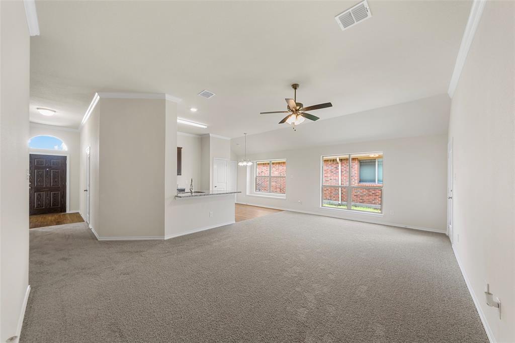 425 Tobin Drive Seagoville, TX 75159 - Photo 10 of 20 Unfurnished living room featuring light colored carpet, baseboards, crown molding, ceiling fan, and recessed lighting